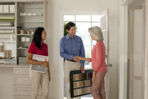 Floor covering consultation Businessman carrying flooring samples with female business partner