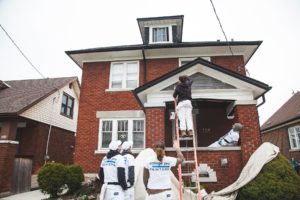 College pro painters painting the exterior of a home