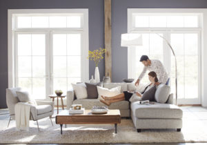 Man and Woman in Living Room Reading Magazine