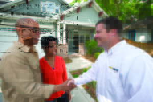 Homeowners shaking hands with restoration contractor