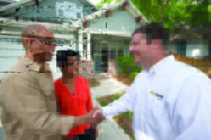 Homeowners shaking hands with restoration contractor