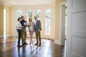 Home inspectors and home owners together reviewing home